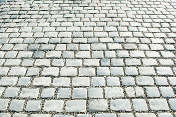 Road paved with cobble stones for your background
