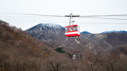 Fototapeta premium Red Cable car at Akechidaira, Nikko landscape with dry tree in Winter season and mountain view