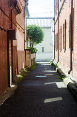 Alley between red brick houses in Honjo City, Saitama Prefecture.