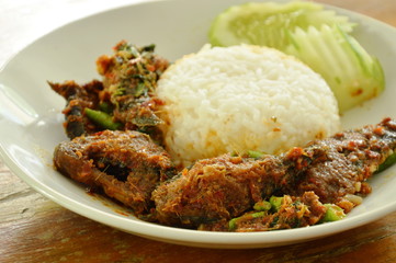 spicy stir fried crispy catfish curry with rice on plate