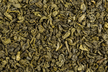 Green tea herbs texture. Organic dried tea leaves. Top view.