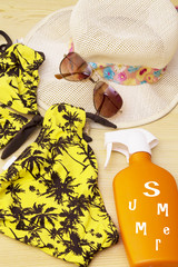 summer accessories, summer hat, sunglasses, bikini and suntan lotion
