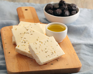 Sliced feta cheese, olives, and olive oil