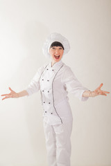 Young girl in the clothes of the cook. Confectioner on a white background.