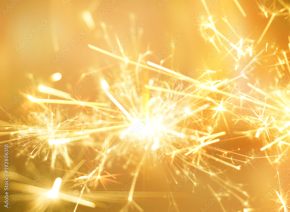 Wall mural Golden sparkler fire for party celebration background