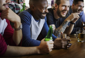 Frieds cheering sport at bar together