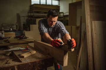 carpenter works with manual and electric equipment