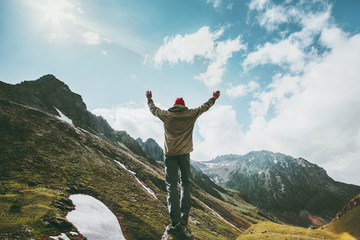 Happy Man raised hands standing on cliff wander mountains view adventure travel lifestyle concept...