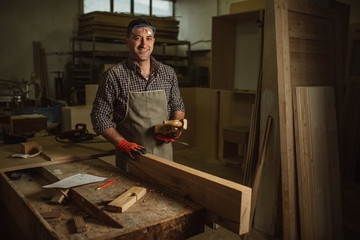 carpenter works with manual and electric equipment