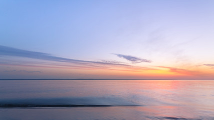 Fototapeta na wymiar sunrise on the water / Early summer morning bright sky Beach