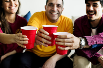 Friends cheering world cup with painted flag