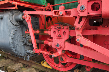 red drive wheel of a steam locomotive