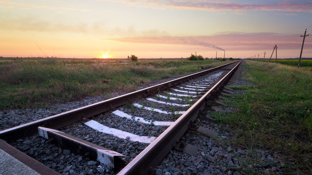 Railway in the steppe / photo right after sunset road leading to the distance