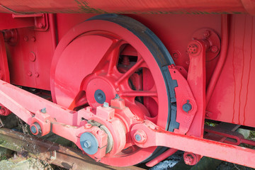 red drive wheel of a steam locomotive