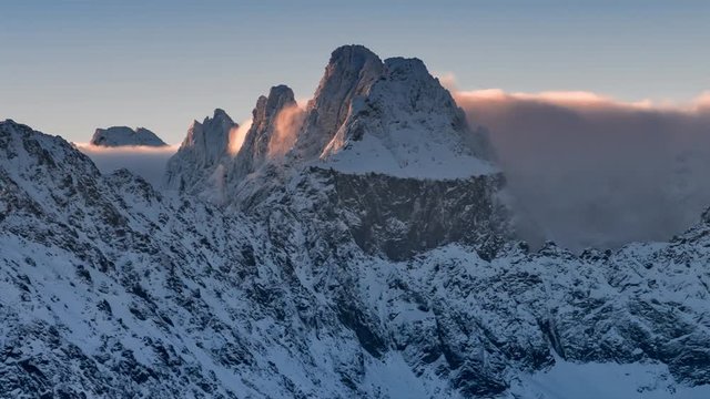 Snowy Tatra mountains peaks over clouds, Poland and Slovakia landscape, time lapse