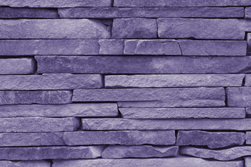 Horizontal stone wall of a nature rock (ultra violet)