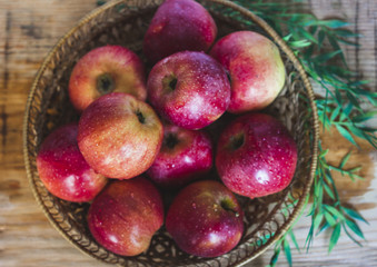 Delicious juicy apples. in a wooden basket. On a wooden table!
On a black background.