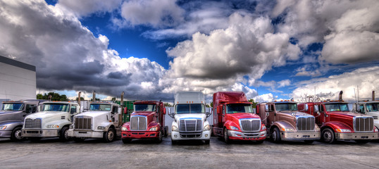HDR image of Semi trucks lined up on a parking lot © hit1912