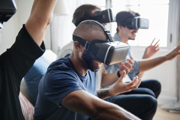 Group of divese friends experiencing virtual reality with VR headset