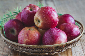 Delicious juicy apples. in a wooden basket. On a wooden table!
On a black background.