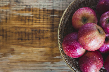 Delicious juicy apples. in a wooden basket. On a wooden table!
On a black background.