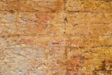 Empty old brick wall texture. Painted wall surface. Grungy brick wall. Building facade with damaged plaster.