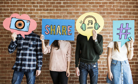 Friends holding up thought bubbles with social media concept icons