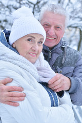 senior couple posing outdoors