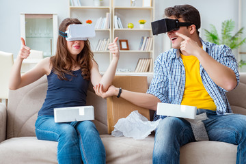 Young family playing games with virtual reality glasses