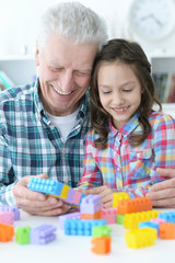 Grandfather  playing with her little granddaughter 