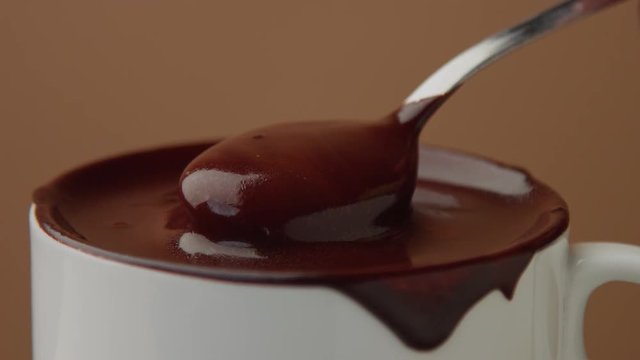 spoon in cup of hot chocolate moving it slowly