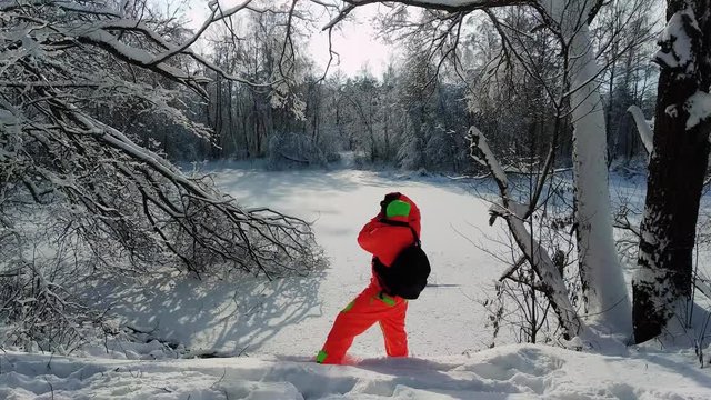 Photographer making a photo of frozen lake.
