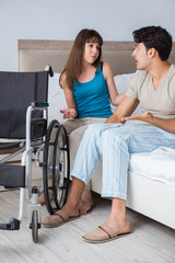Fototapeta na wymiar Desperate man on wheelchair with his sad wife