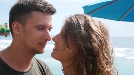 Romantic young couple kissing on shore cliff, Bali