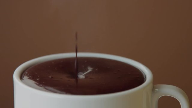 hot chocolate pouring in white cup