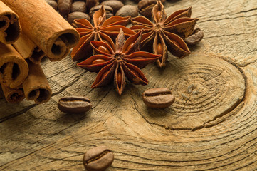 Coffee beans and anise on wooden board