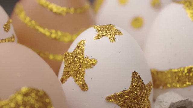 panned shoot closeup of easter egg in golden glitter