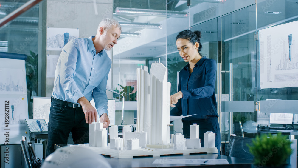 Aufkleber in the architectural bureau female engineer brings blueprints and shows them to senior architect, th