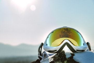 yellow ski goggles and snowboarder in the mountains