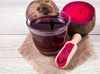Healthy beetroot juice and fresh vegetables on wooden background. - 192821171