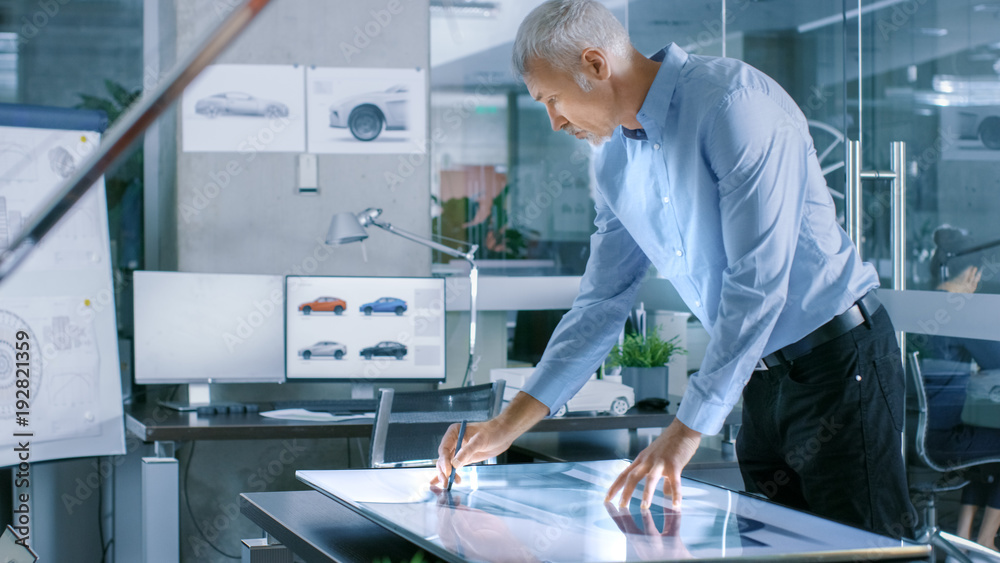 Aufkleber experienced automotive designer works with digital display graphics tablet touschreen table, drawing