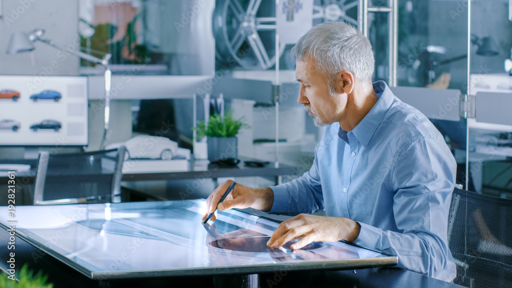 Aufkleber experienced automotive designer works with digital display graphics tablet touschreen table, drawing