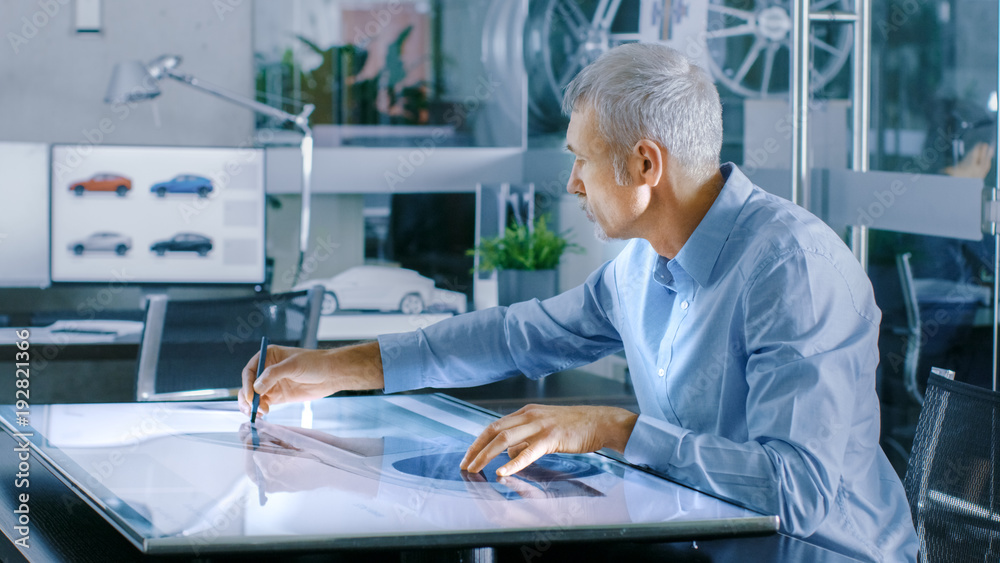 Aufkleber experienced automotive designer works with digital display graphics tablet touschreen table, drawing