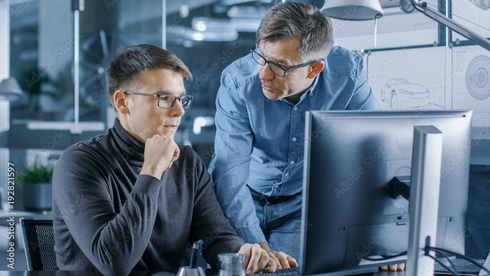 Poster experienced senior engineer consults young designer about project, they have discussion and work on 