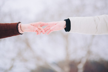 Loving couple in a pine forest in winter