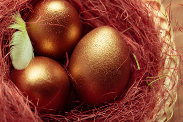 gold eggs on wooden table