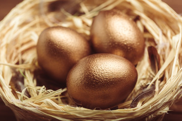 gold eggs on wooden table