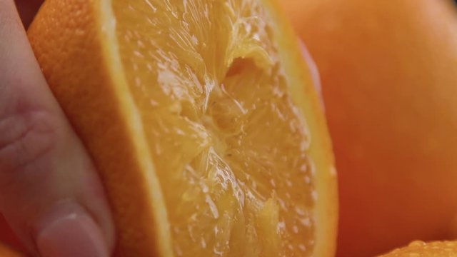 closeup of oranges on black background. Fresh with drops of water on peel. closeup of wet orange cut. Smudge orange for juice