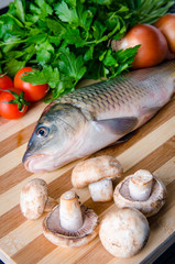 Uncooked fish on cutting board in meal preparation concept