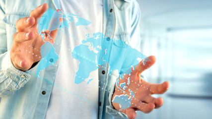 Businessman holding a Connected world map on a futuristic interface - 3d render